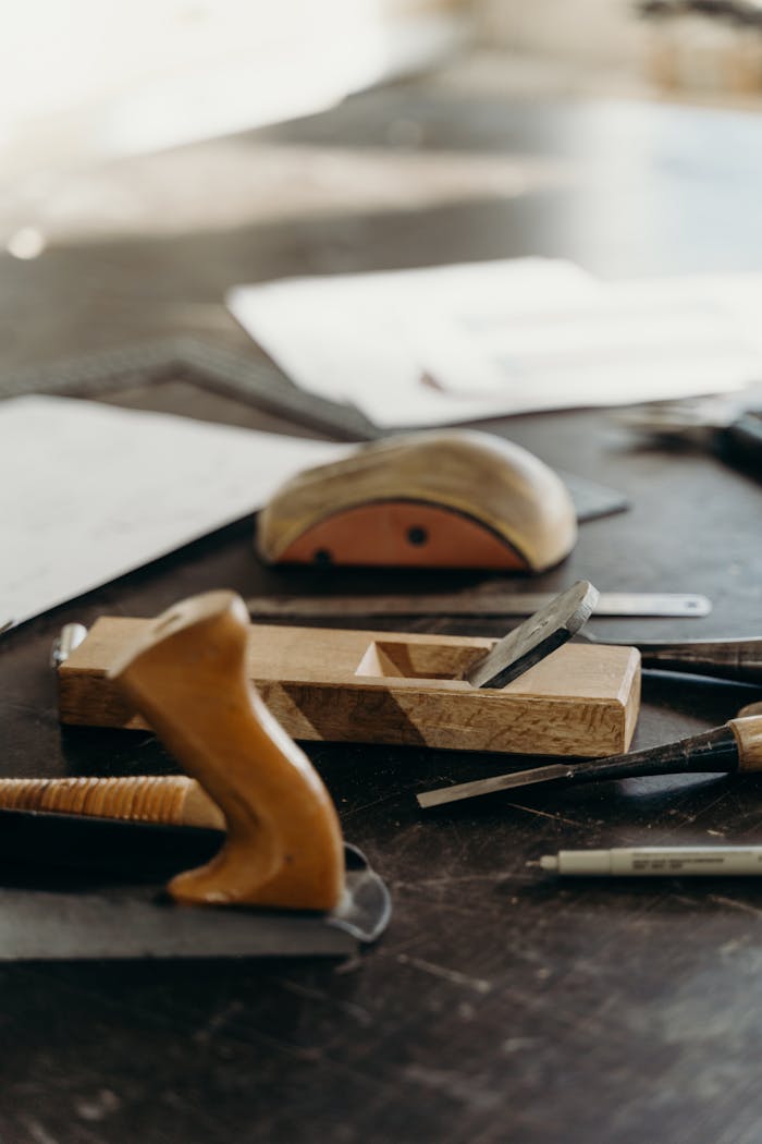 Close-up of woodworking tools on a craftsman's workbench, highlighting creativity and carpentry.